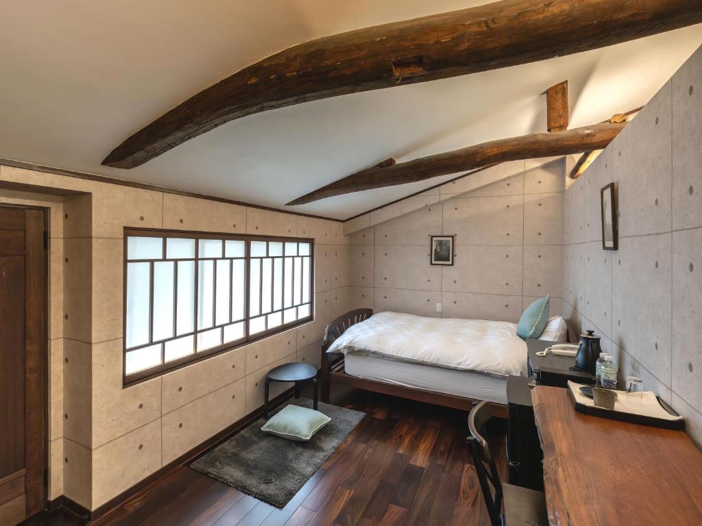 Postel nebo postele na pokoji v ubytování Machiya Hotel oyado baison