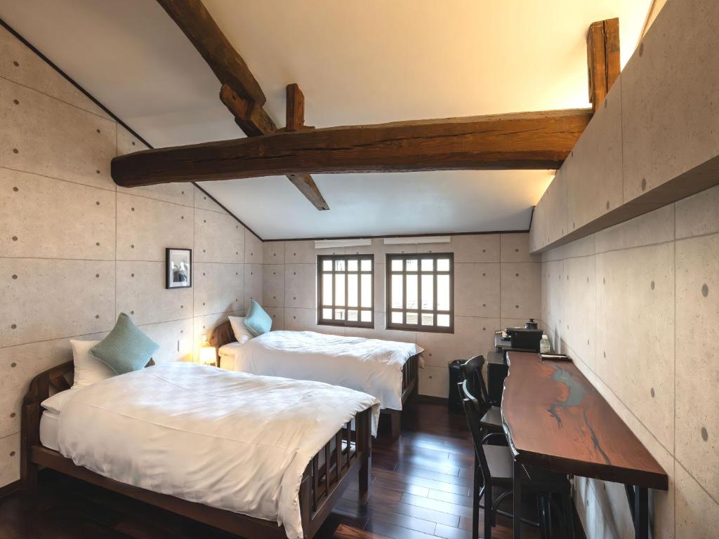 Postel nebo postele na pokoji v ubytování Machiya Hotel oyado baison