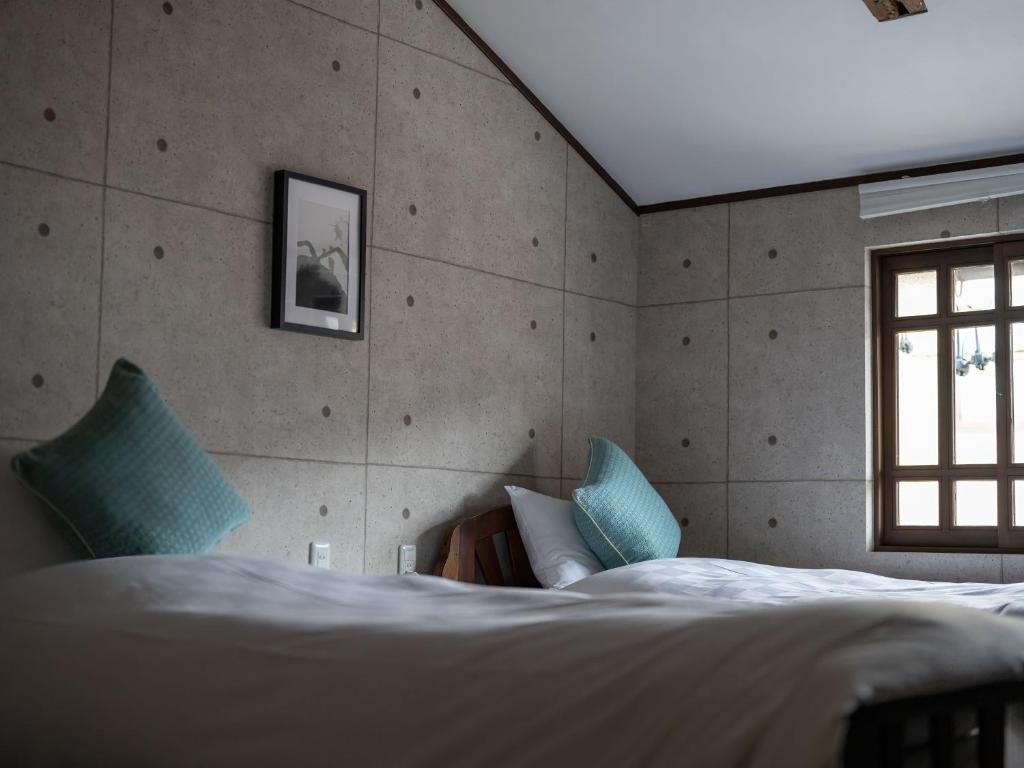 Postel nebo postele na pokoji v ubytování Machiya Hotel oyado baison