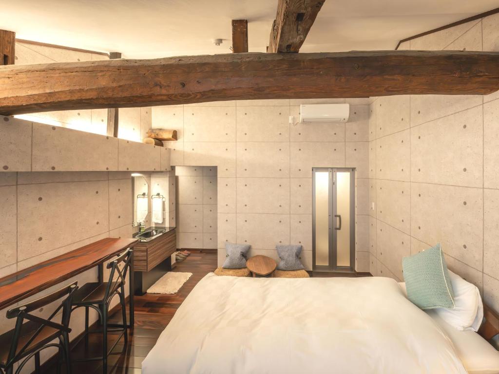 Postel nebo postele na pokoji v ubytování Machiya Hotel oyado baison