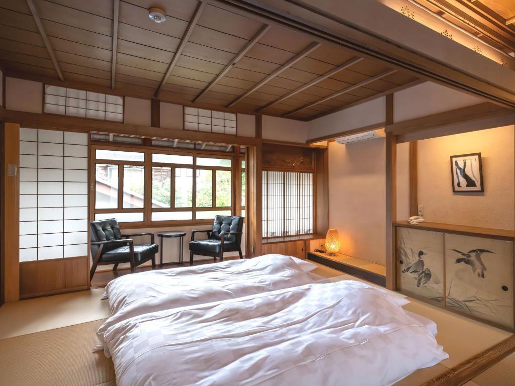 Postel nebo postele na pokoji v ubytování Machiya Hotel oyado baison