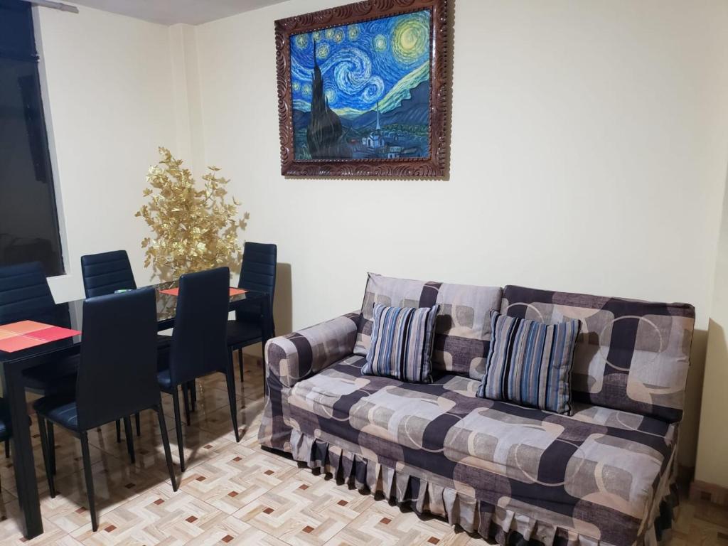a living room with a couch and a table with chairs at Carosvi Home in Lima