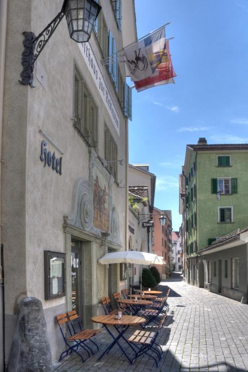 a group of tables and umbrellas outside of a building at Zunfthaus zur Rebleuten in Chur
