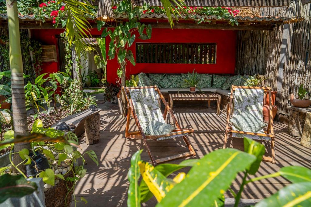 two chairs and a couch on a patio at Pousada Jangada Prea in Prea