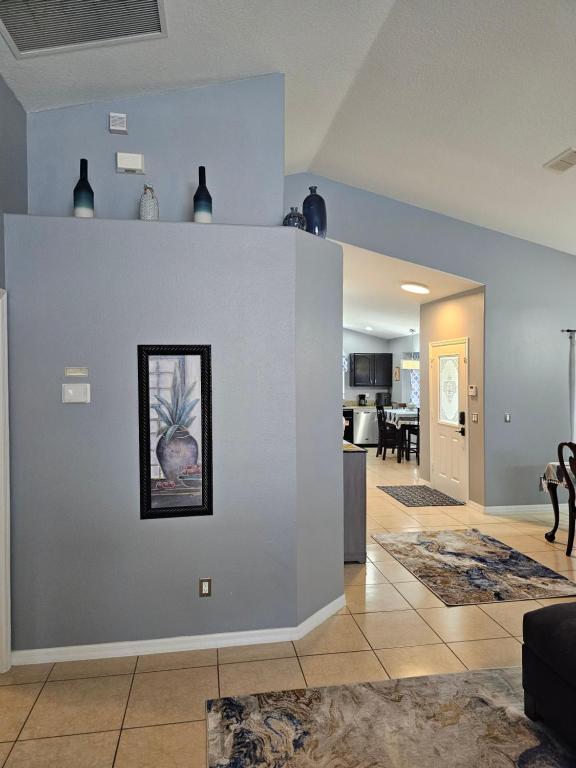 a living room with a wall with a picture on it at Minnie Heaven in Kissimmee