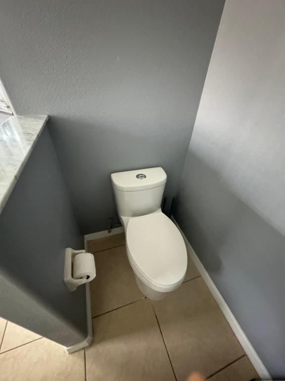 a small bathroom with a toilet in the corner at Minnie Heaven in Kissimmee