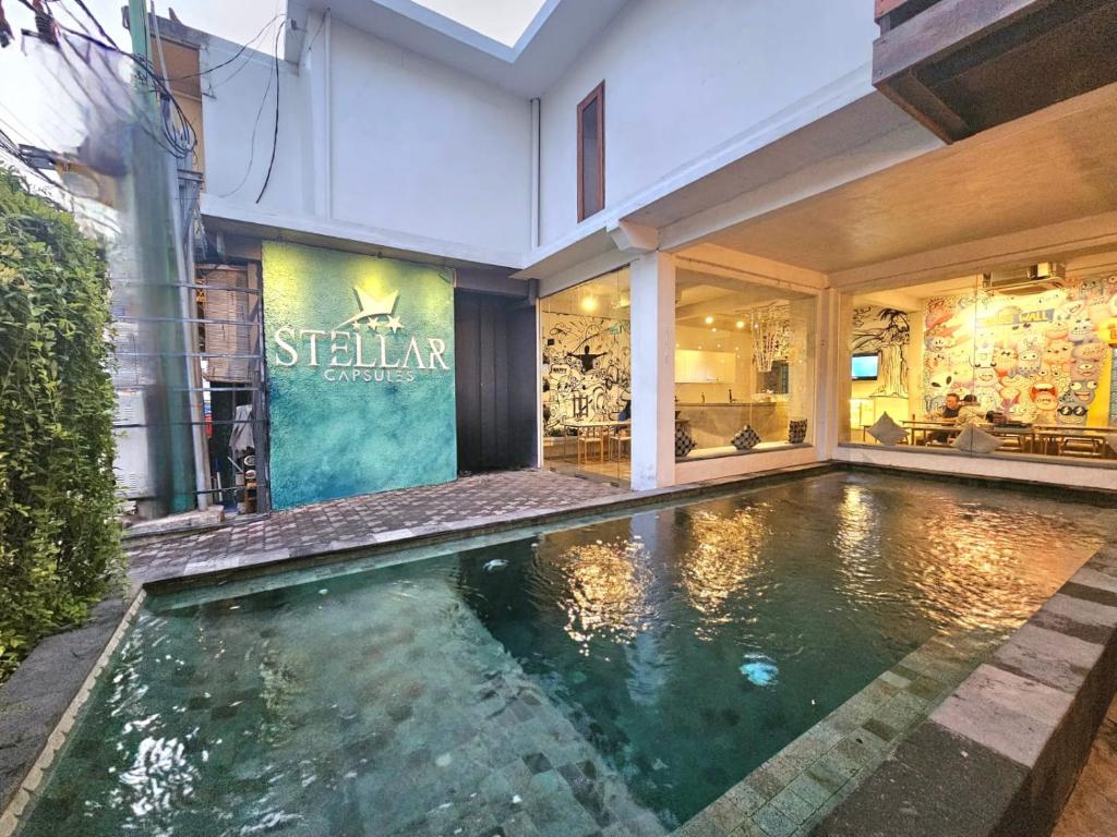 a swimming pool in the middle of a house at Stellar Capsules in Seminyak