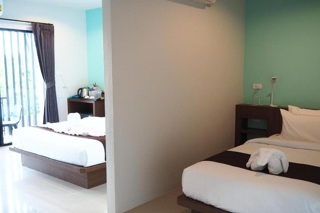 Postel nebo postele na pokoji v ubytování Friendly Hotel Krabi