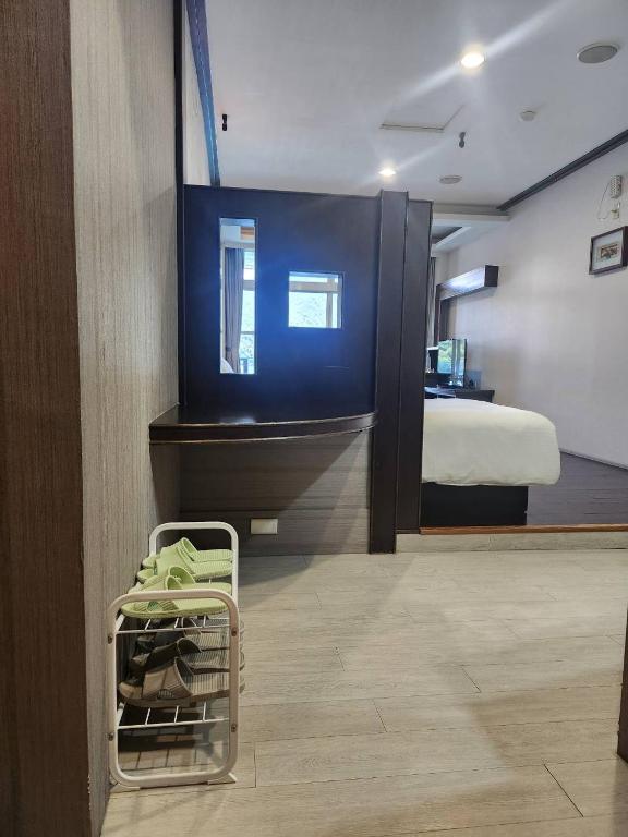 a room with a bed and a luggage cart in it at Sun Fog Hotel in Yuchi