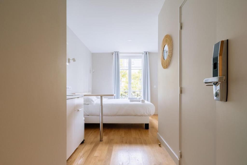 Posteľ alebo postele v izbe v ubytovaní Relaxing Studio Apartment in the Heart of Paris