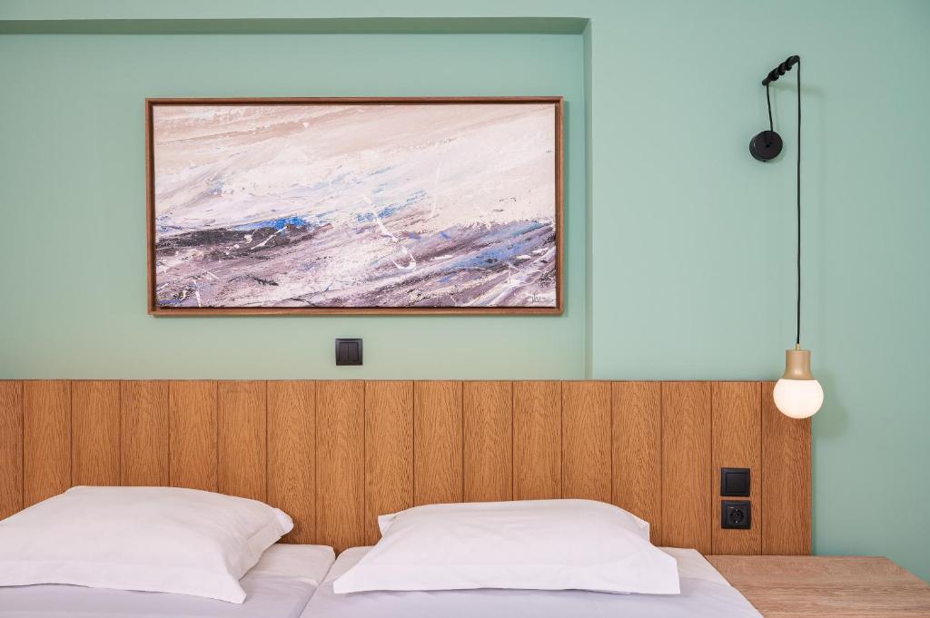 A bed or beds in a room at Emily Hotel