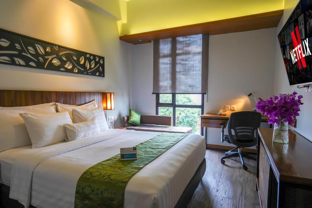 Postel nebo postele na pokoji v ubytování BATIQA Hotel Palembang