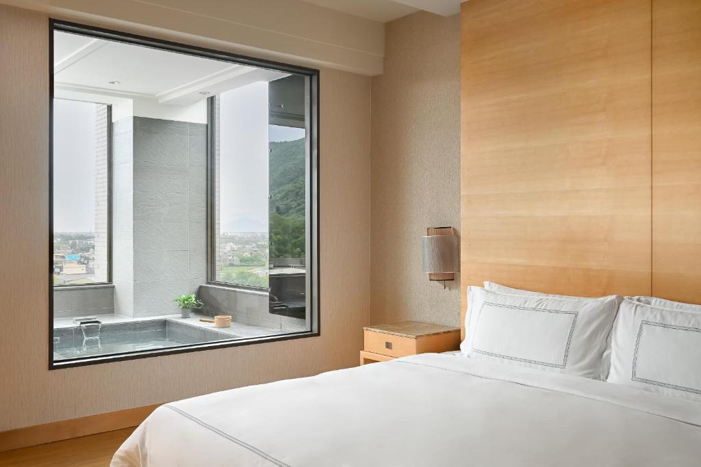 Postel nebo postele na pokoji v ubytování Evergreen Resort Hotel - Jiaosi