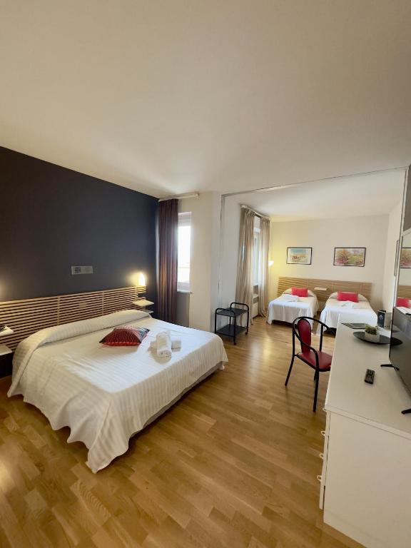 Postel nebo postele na pokoji v ubytování Hotel Quadrifoglio