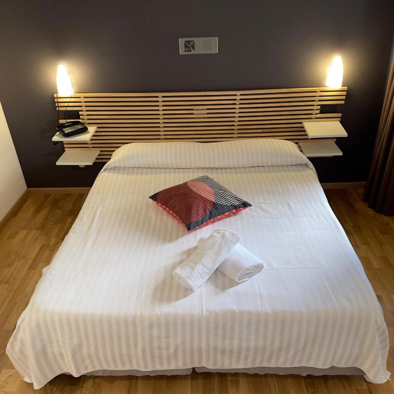 Postel nebo postele na pokoji v ubytování Hotel Quadrifoglio