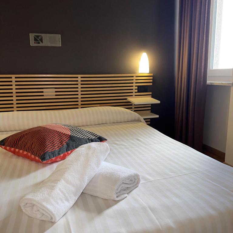 Postel nebo postele na pokoji v ubytování Hotel Quadrifoglio