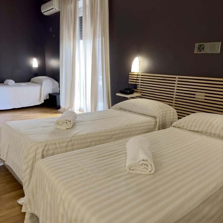 Postel nebo postele na pokoji v ubytování Hotel Quadrifoglio