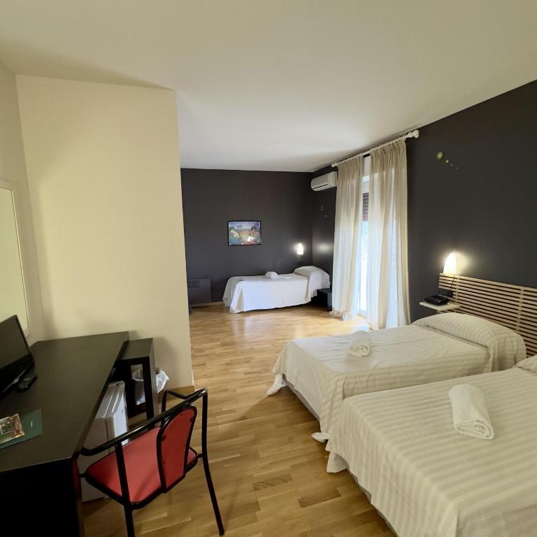 Postel nebo postele na pokoji v ubytování Hotel Quadrifoglio