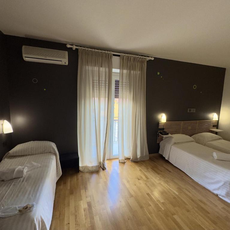 Postel nebo postele na pokoji v ubytování Hotel Quadrifoglio