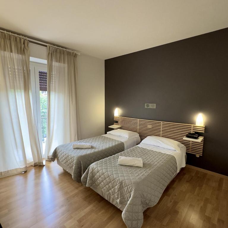 Postel nebo postele na pokoji v ubytování Hotel Quadrifoglio