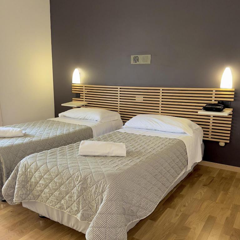 Postel nebo postele na pokoji v ubytování Hotel Quadrifoglio