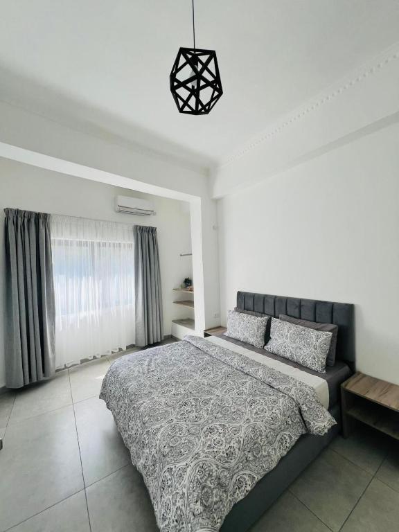 a bedroom with a large bed and a window at Jordan Tower Hotel in Amman