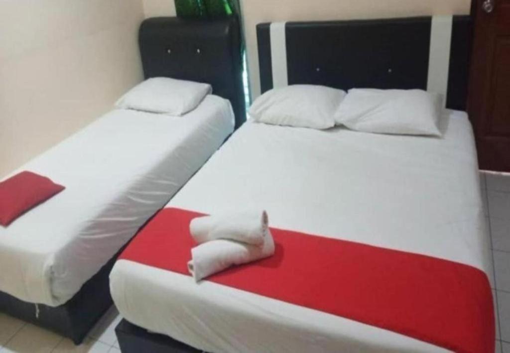Postel nebo postele na pokoji v ubytování Hotel Iskandar Perak