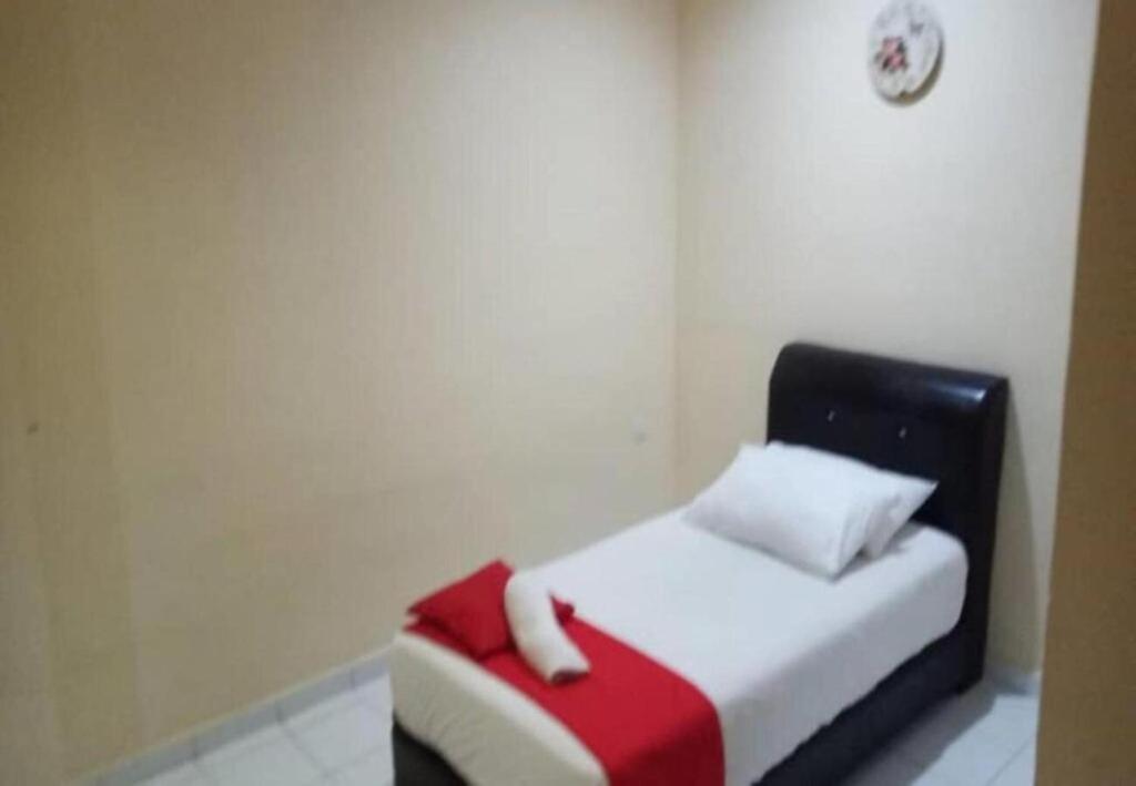 Postel nebo postele na pokoji v ubytování Hotel Iskandar Perak