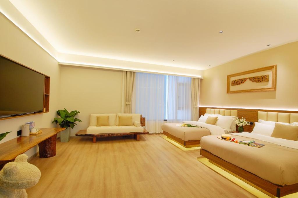 TV a/nebo společenská místnost v ubytování 夕露小榭南门机场大巴店Xiluxiaoxie MUXIN INN