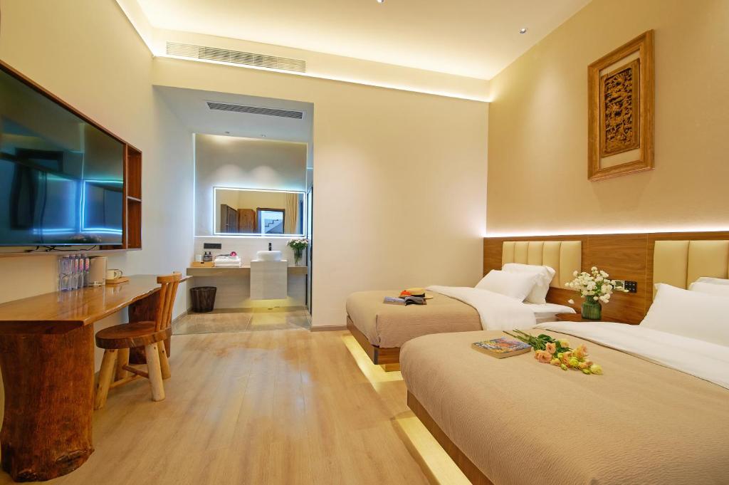TV a/nebo společenská místnost v ubytování 夕露小榭南门机场大巴店Xiluxiaoxie MUXIN INN