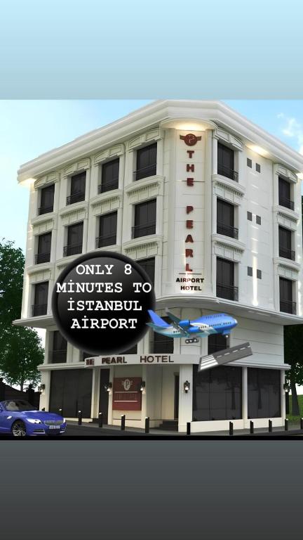 a white building with a sign in front of it at The Pearl Airport Hotel in Arnavutköy
