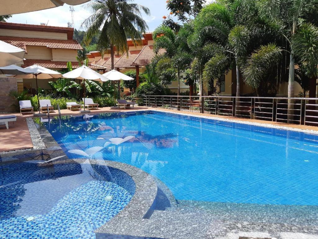 a large swimming pool with blue water in a resort at Castaways Resort Phu Quoc in Phu Quoc
