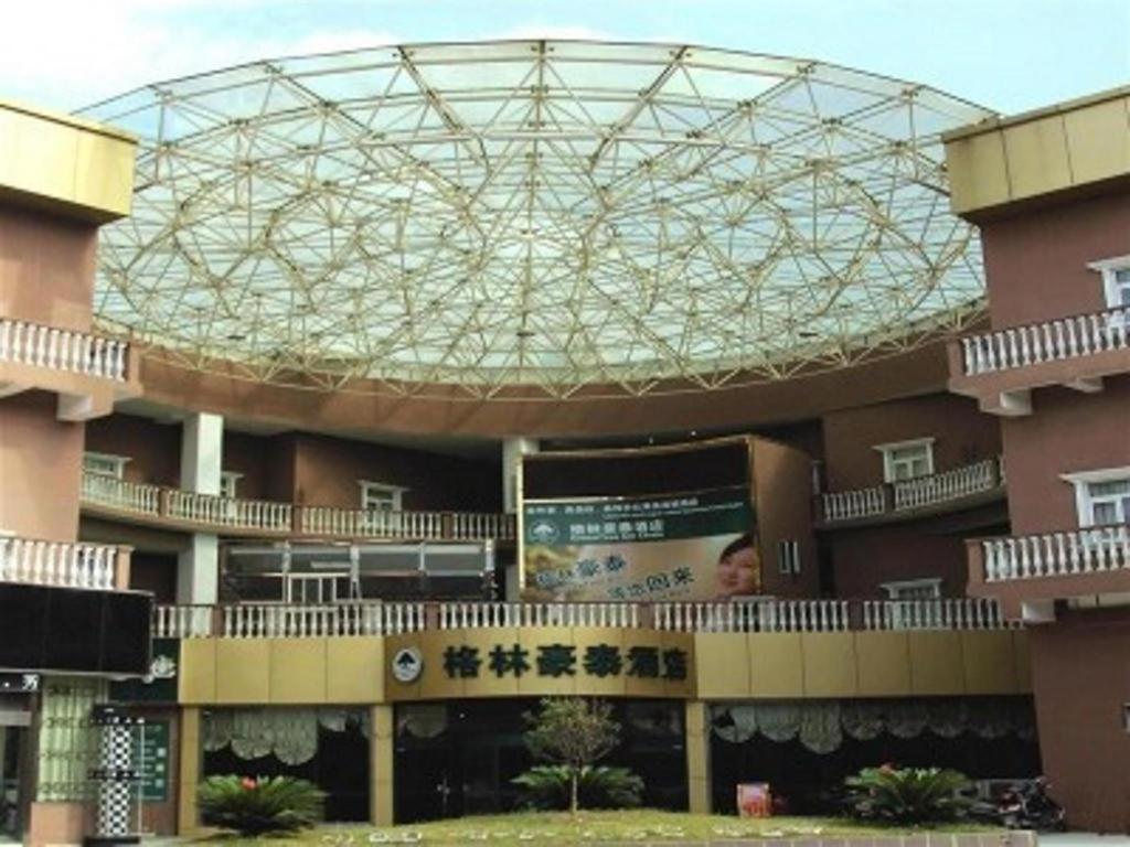 a large building with a glass dome on top of it at GreenTree Inn Kunshan Shimao Plaza Business Hotel in Suzhou