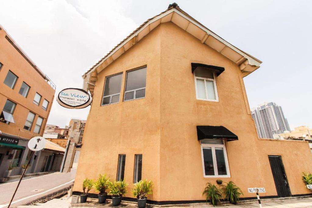 a brown building with a sign in front of it at OYO 228 Sea View Hotel in Colombo