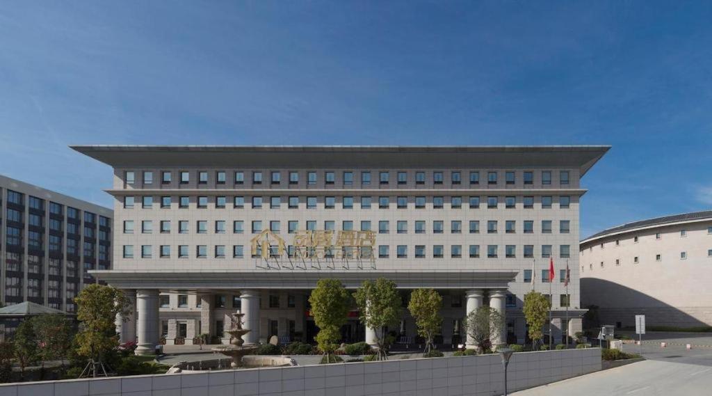 a large white building with a lot of windows at Cozy Hotel Xiamen in Xiamen