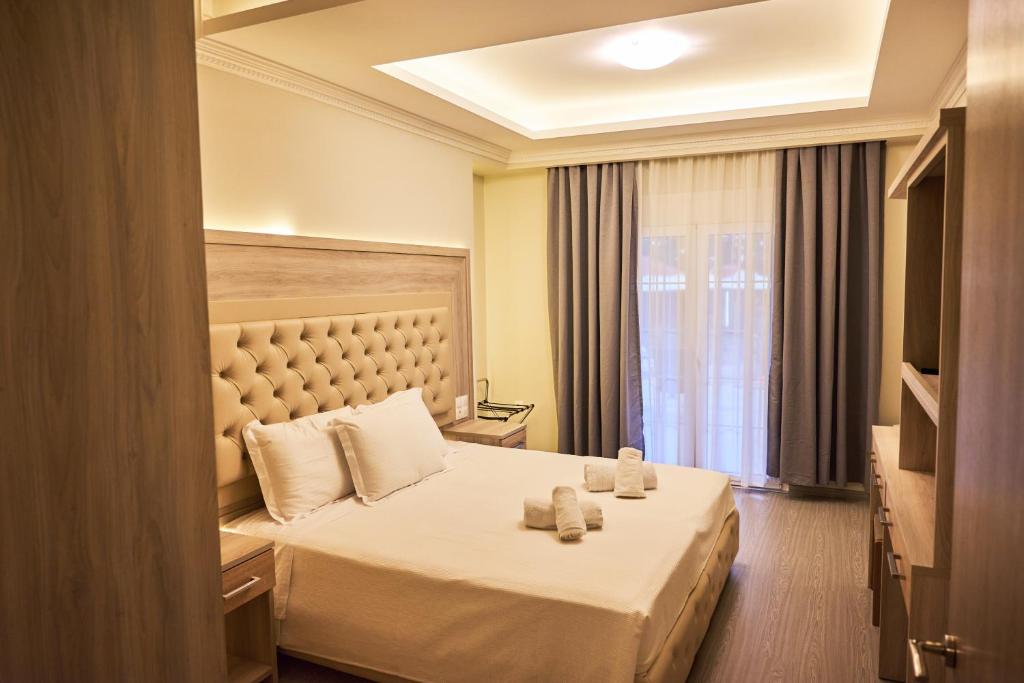 Posteľ alebo postele v izbe v ubytovaní Famissi Eden Hotel