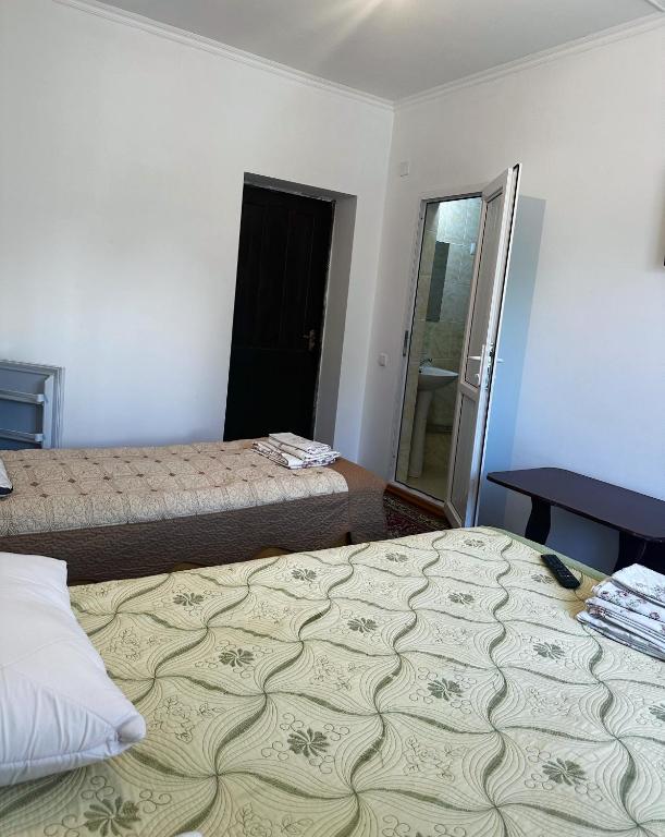 Postel nebo postele na pokoji v ubytování Guest House Arbat