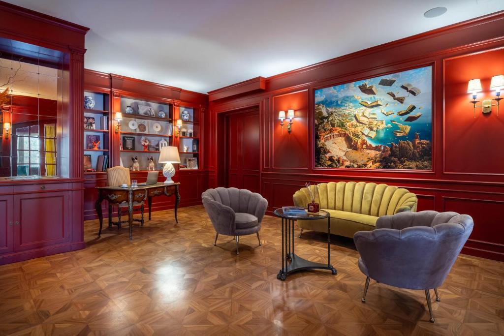 a living room with a painting on the wall at Grand Hotel San Pietro Taormina in Taormina