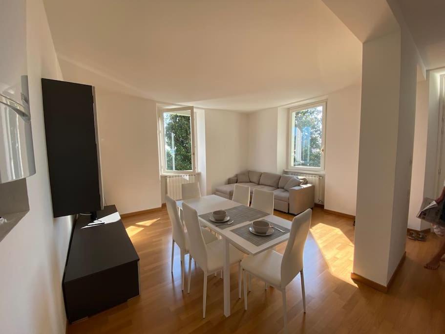 a living room with a table and chairs and a couch at Lake pool&garden house in Meina