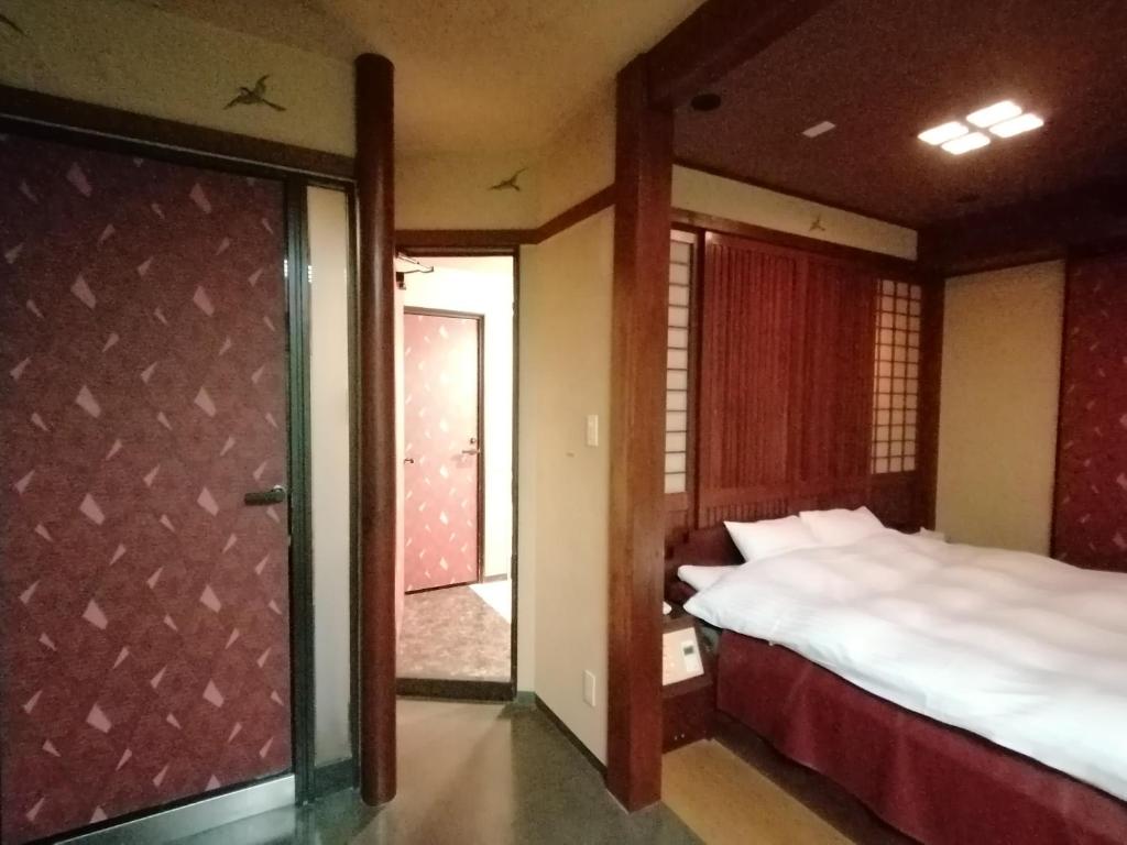 Postel nebo postele na pokoji v ubytování 月のあかり