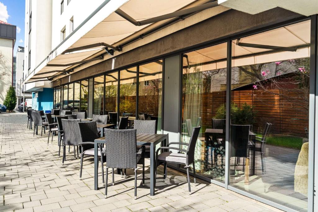 a row of tables and chairs in front of a building at Hampton by Hilton Cluj-Napoca in Cluj-Napoca