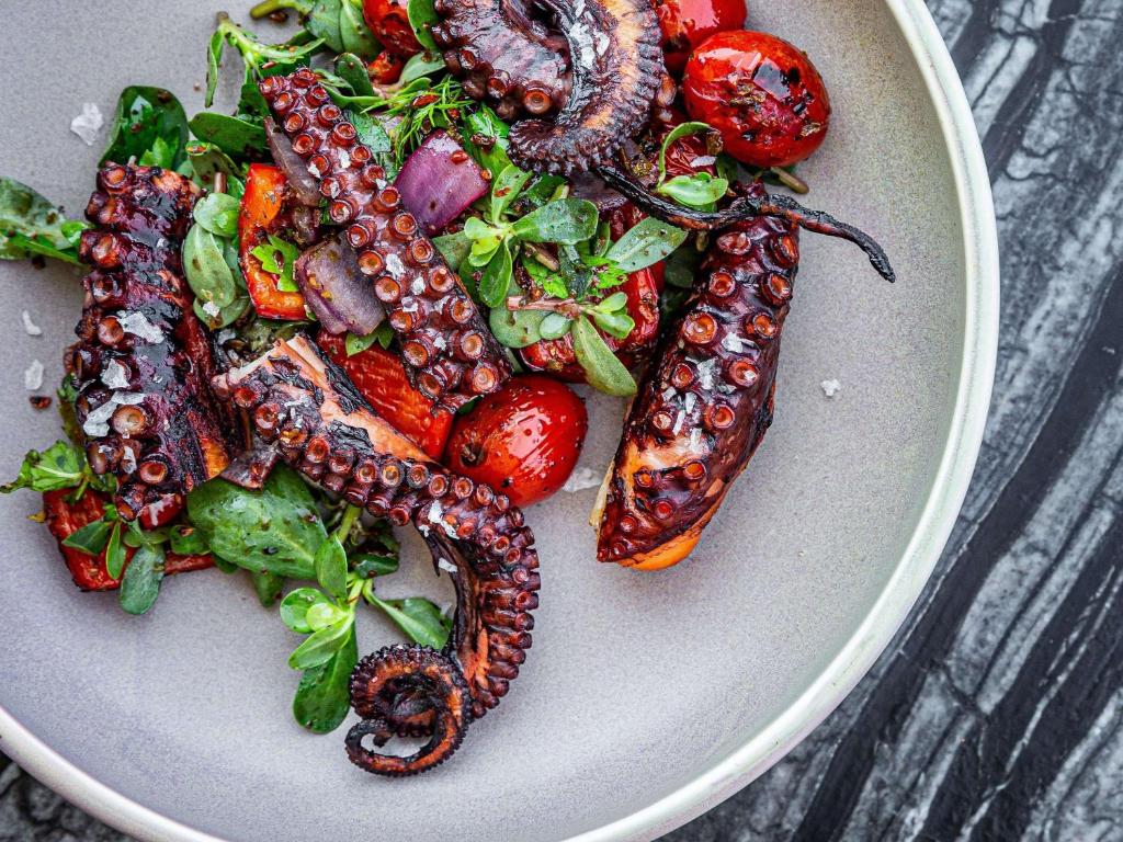 a plate of vegetables with corn snakes and tomatoes at Novotel Istanbul Bosphorus Hotel in Istanbul