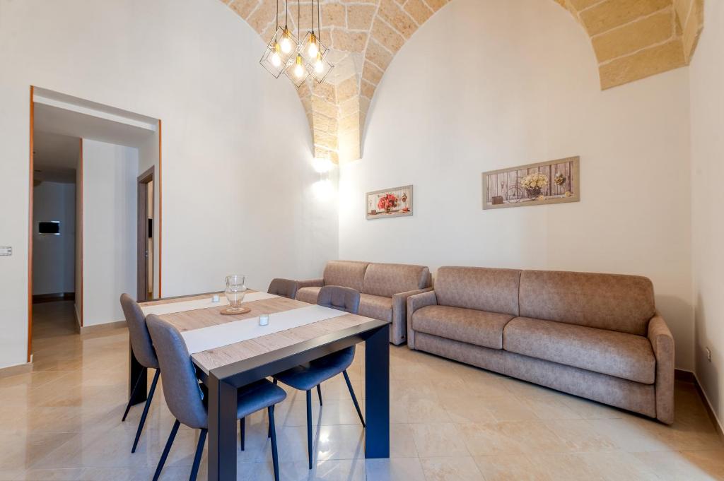 a living room with a table and a couch at San Giorgio Apartment in Cavallino di Lecce