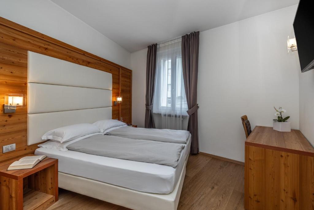 Postel nebo postele na pokoji v ubytování Albergo Tuenno