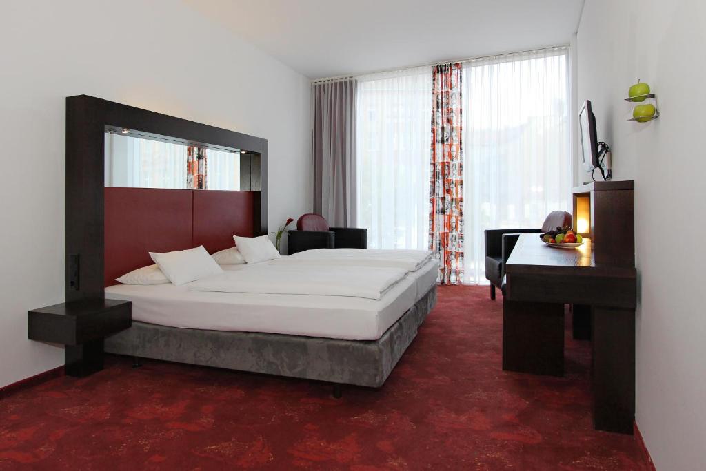 Postel nebo postele na pokoji v ubytování ARCOTEL Velvet Berlin
