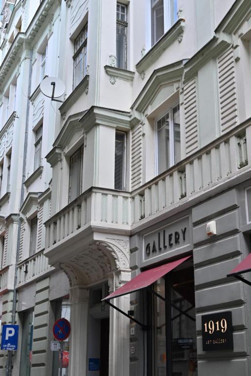 a white building with a bakery sign on a street at Rina Apartments in Sarajevo