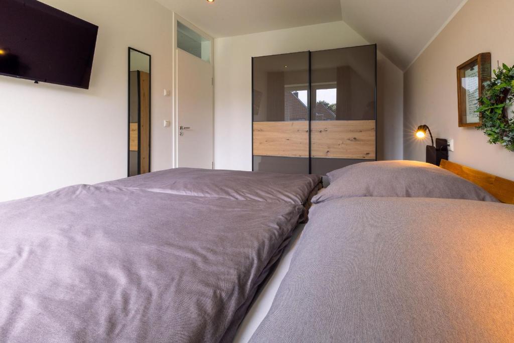 Postel nebo postele na pokoji v ubytování Ferienhaus Liegeplatz Dangast