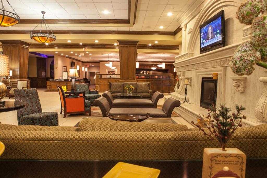 a large living room with a couch and a fireplace at Decatur Conference Center and Hotel in Decatur