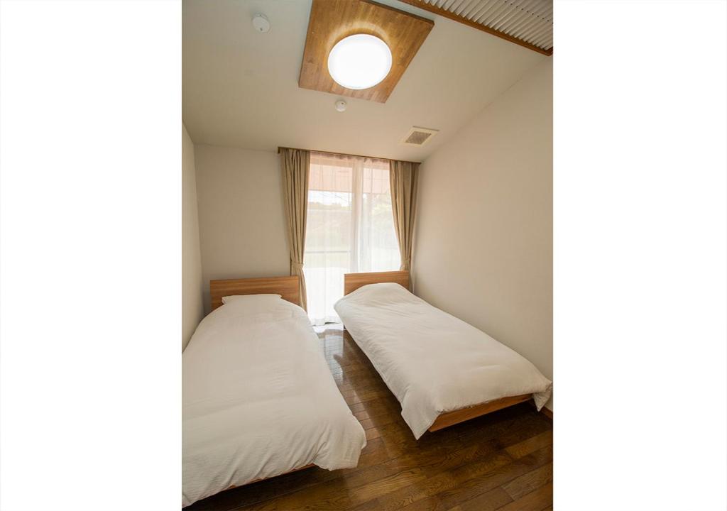 Postel nebo postele na pokoji v ubytování Villa ISE shima