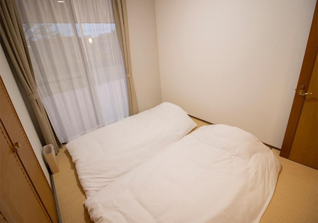 Postel nebo postele na pokoji v ubytování Villa ISE shima